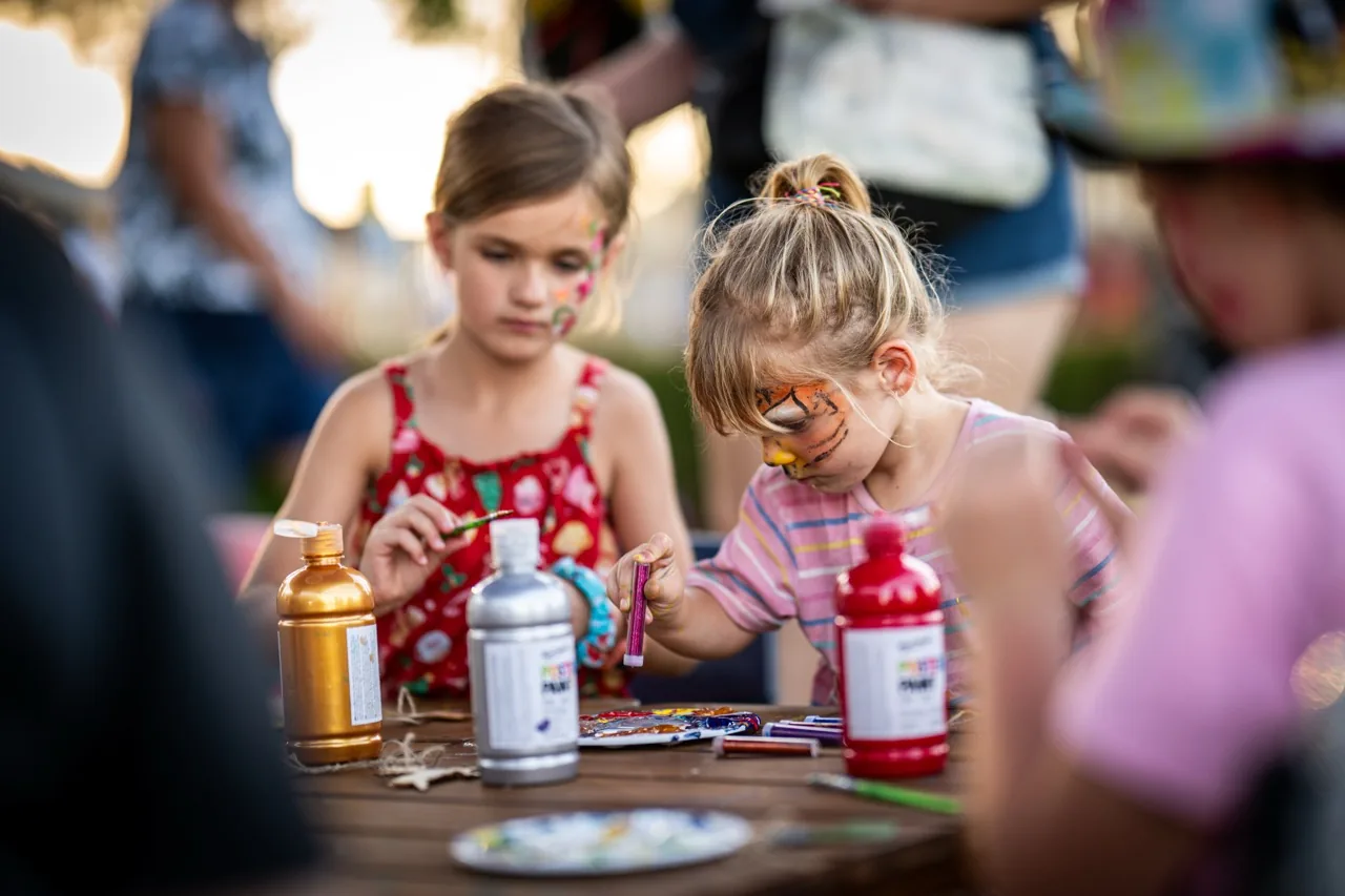 Children face painting at a community event