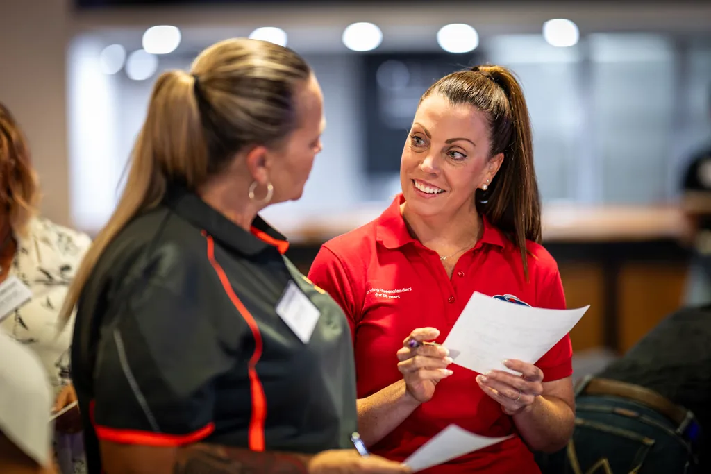 Two businesswomen in conversation at a networking event