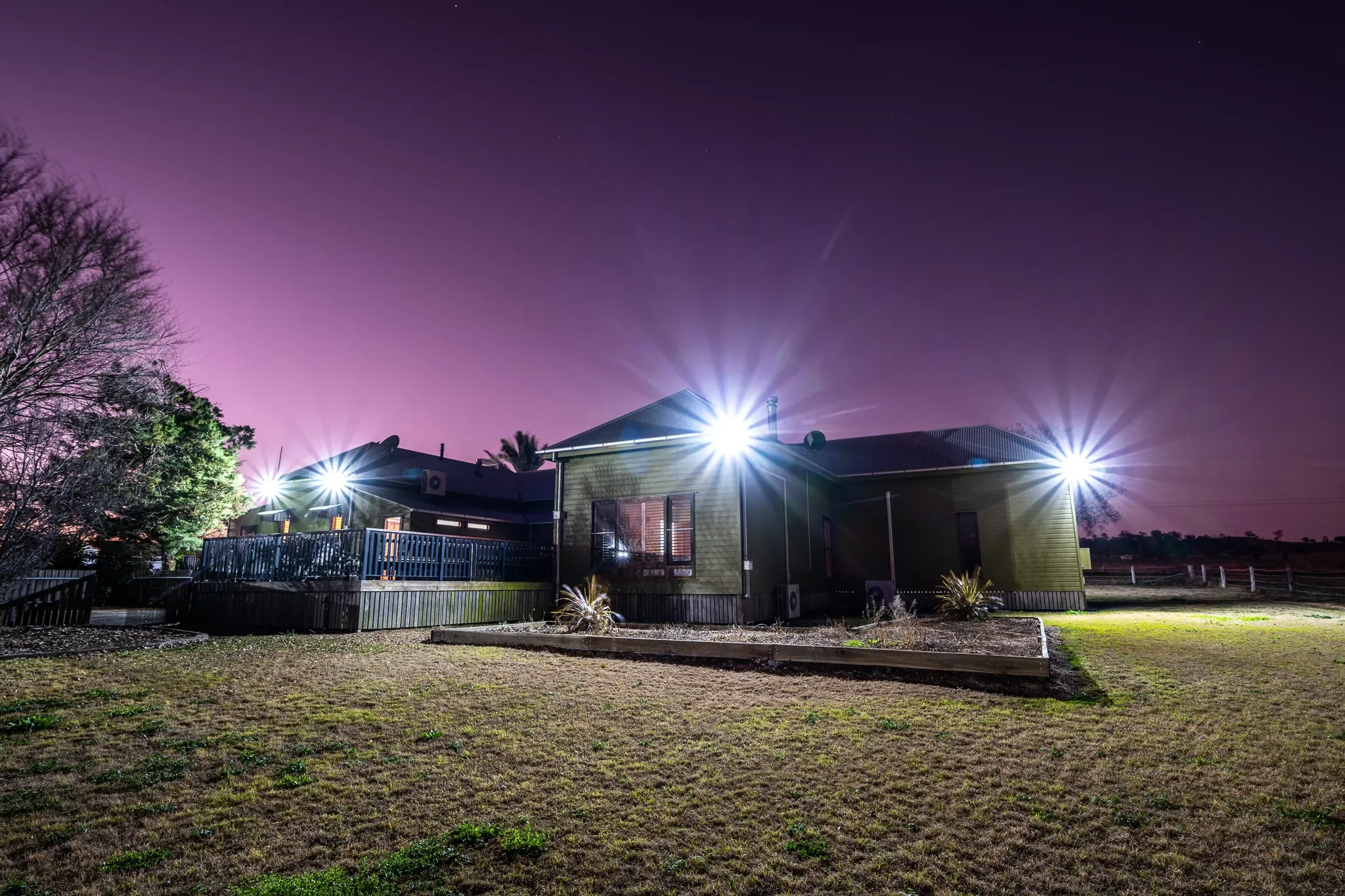 The same standard, at home: a family home lit after dark
